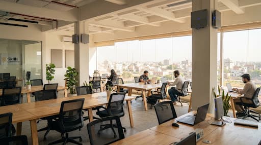 An open co-working space with desks and large windows